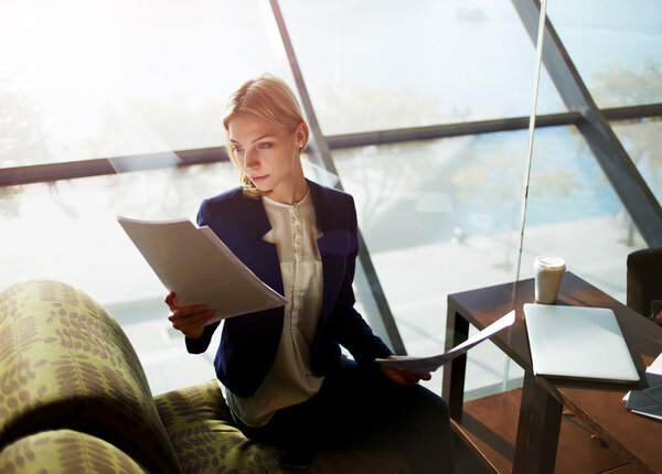 Attractive businesswoman examining paperwork