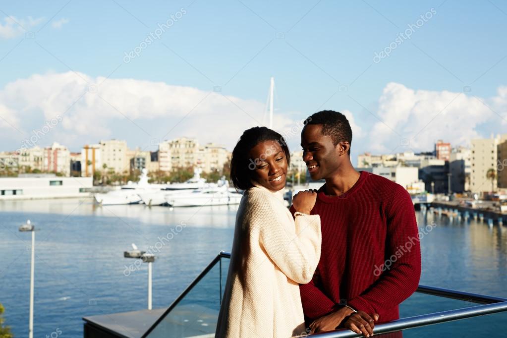 Hugging couple on modern balcony