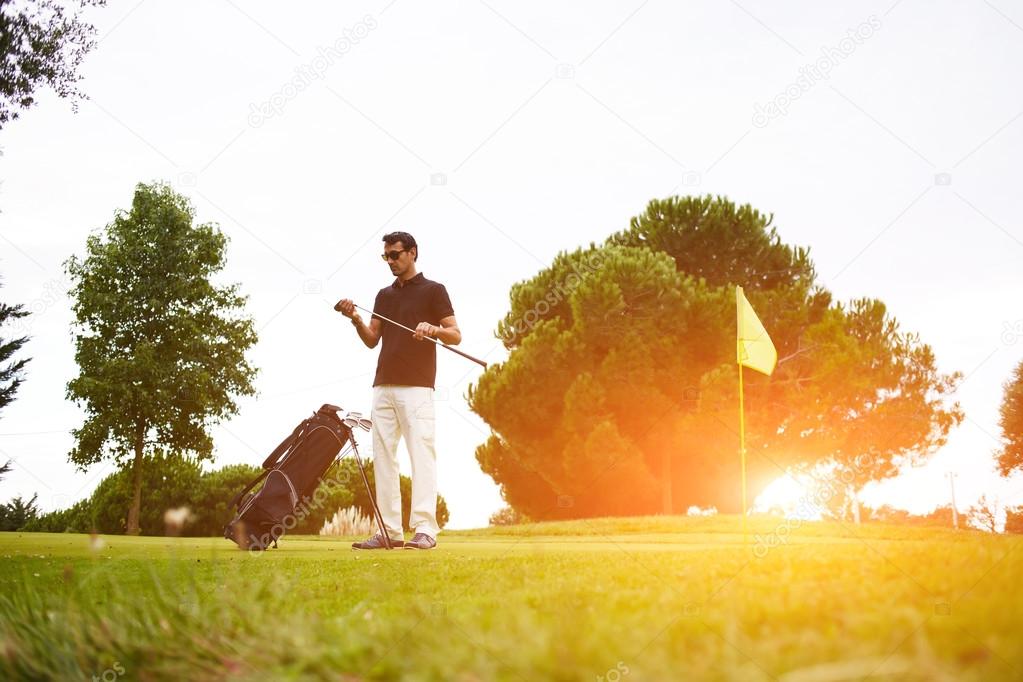 Man playing golf at beautiful summer day