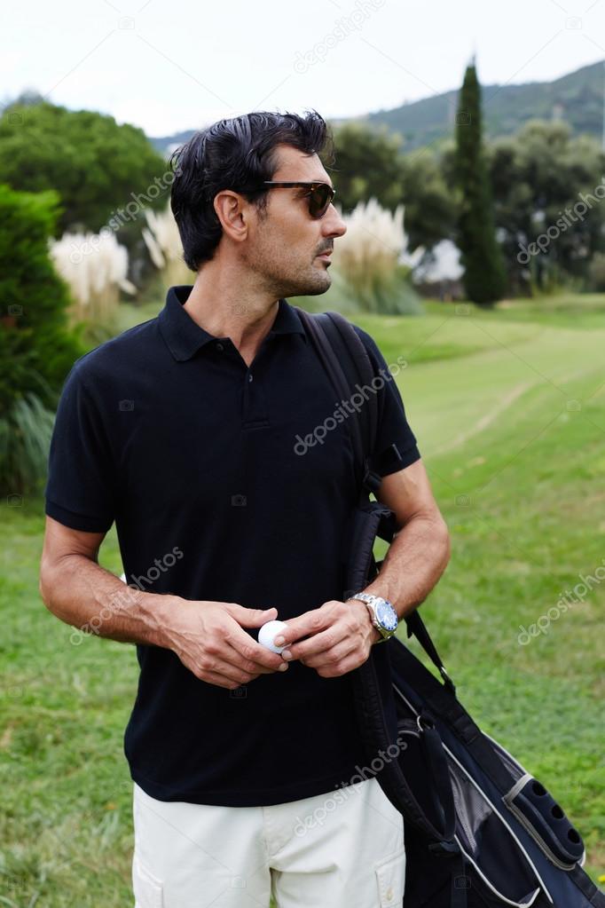 Golf player standing on golf course