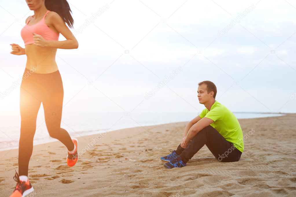 Couple working out against the sea