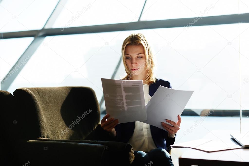 Businesswoman reading papers or documents