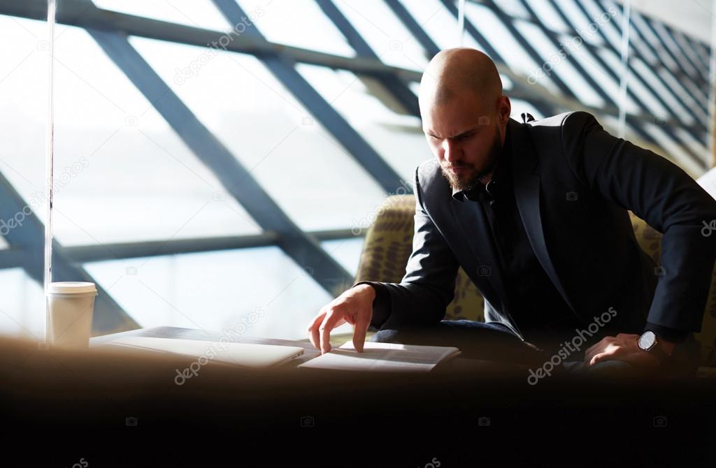 Businessman examining paperwork