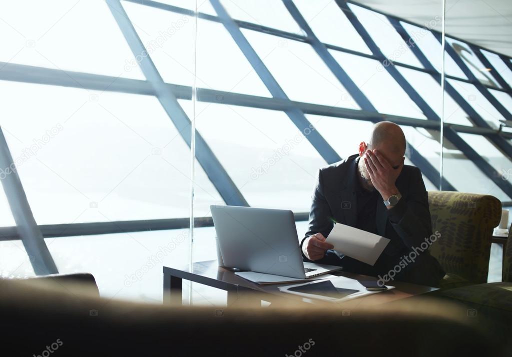 Businessman surrounded by paperwork