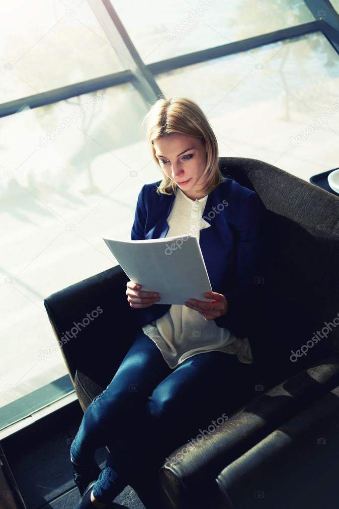 Attractive businesswoman examining paperwork