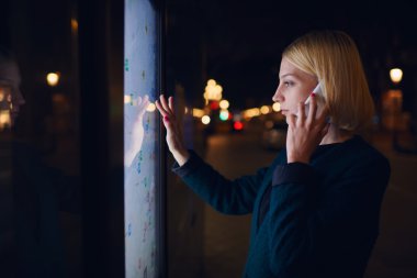Woman  speaking on smartphone in city