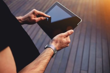 male student hands using touchpad