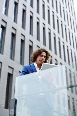 businessman using touchpad browsing outdoors