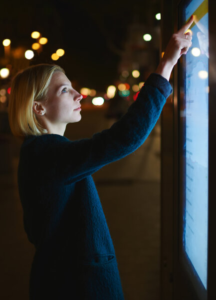 female using automated teller machine