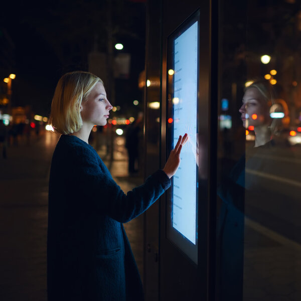 female using automated teller machine
