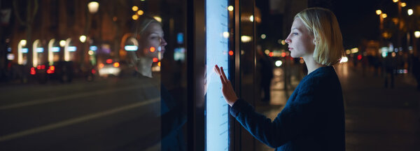 woman using automated teller machine