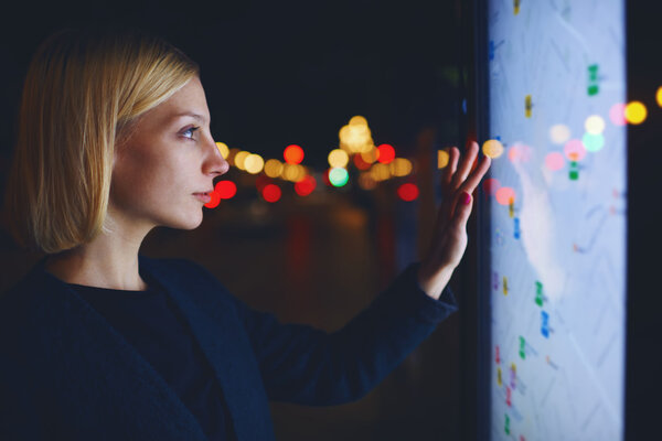 woman standing in front of big GPS screen