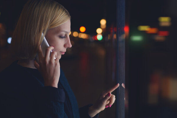 Woman  speaking on smartphone in city