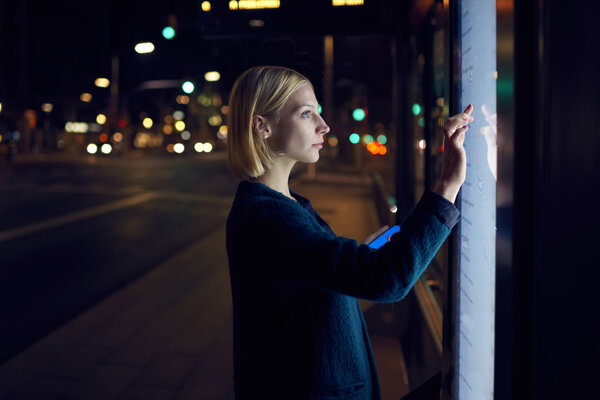 woman using touch sensitive display on street