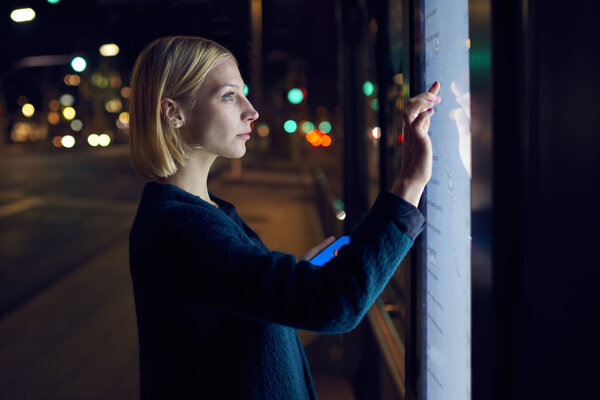 woman using touch sensitive display on street