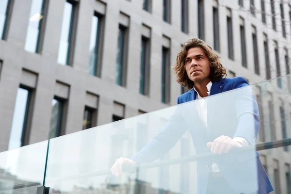 Handsome man leaning on glassy fence — Stok fotoğraf