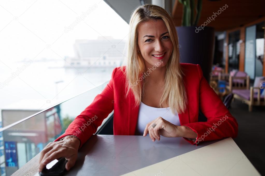 smiling elegant woman sitting at cafe