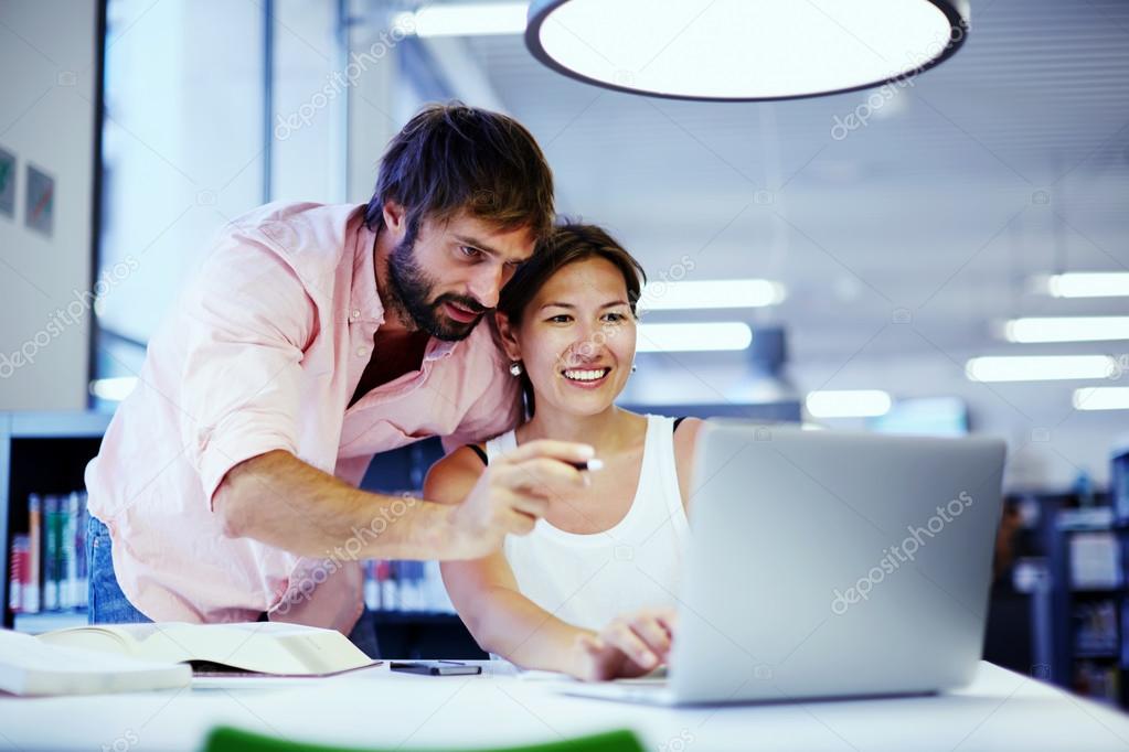 businesswoman getting advice from office colleague