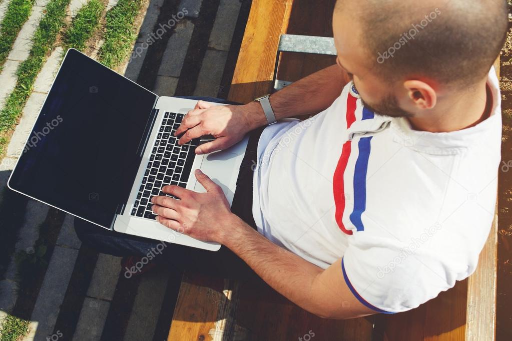 freelancer working on computer in park