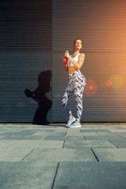 Fit woman with perfect figure with energy drink clipart