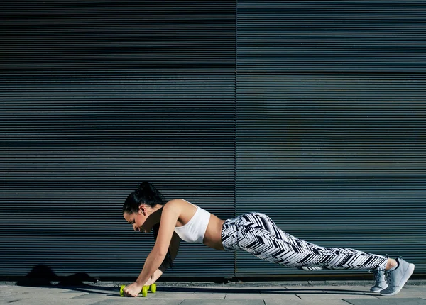 Mulher fazendo press ups com halteres — Fotografia de Stock