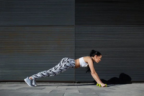 Mulher fazendo press ups com halteres — Fotografia de Stock