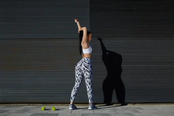 Athletic woman stretching her arms — Stock Photo, Image