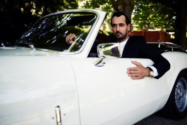 wealthy businessman in luxury car clipart