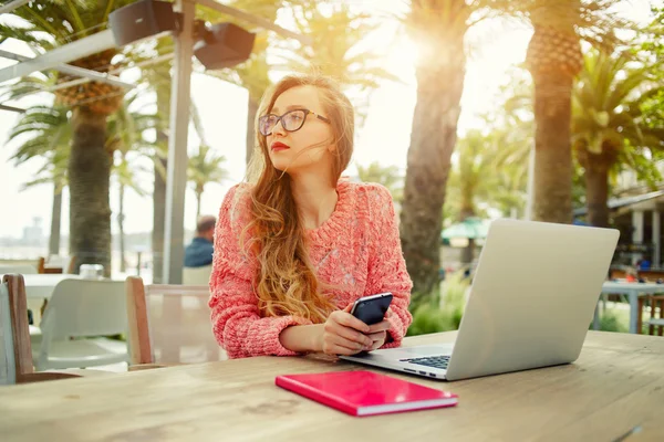 Female freelancer working outdoors Stock Image
