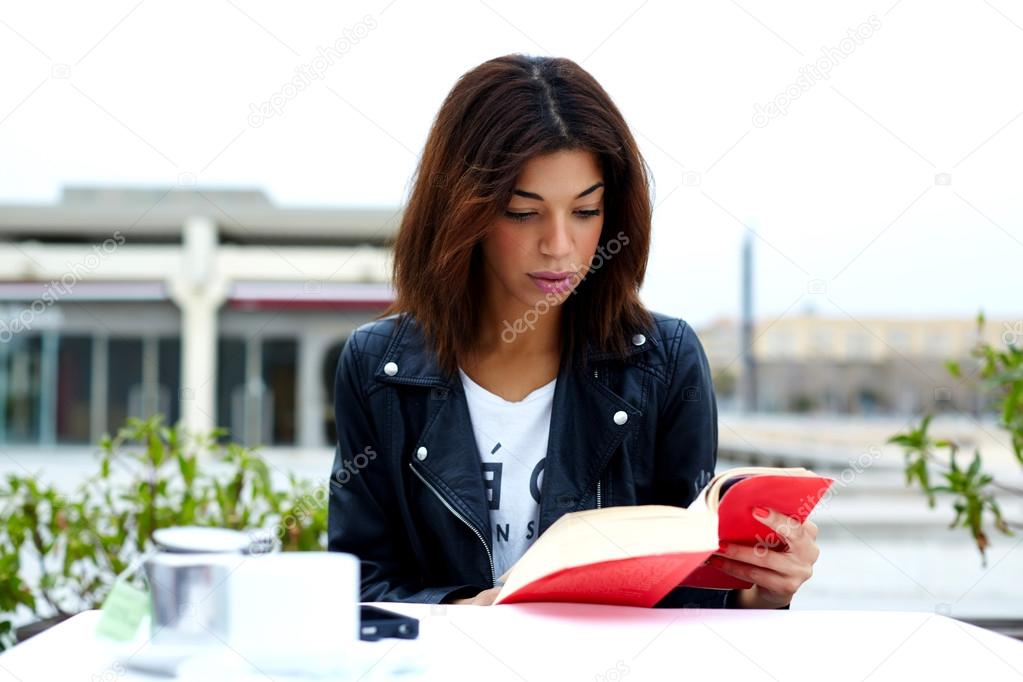Charming woman with book in restaurant