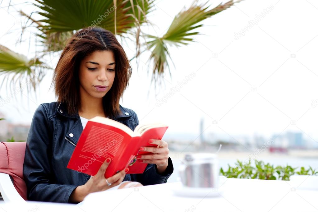 afro american woman enjoying a interesting book