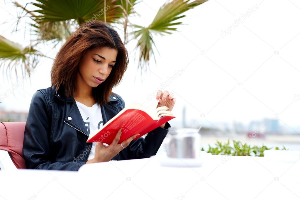 afro american woman enjoying a interesting book