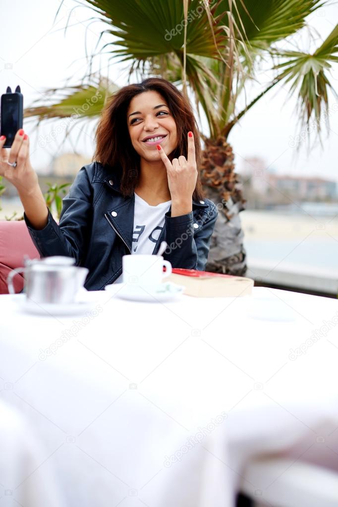 Tourist with mobile phone making selfie