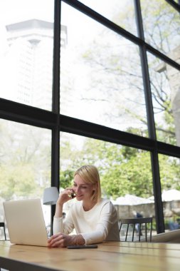 Woman working on notebook in coffee shop