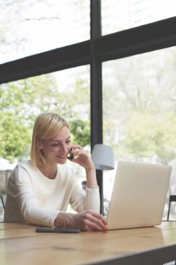 Woman working on notebook in coffee shop