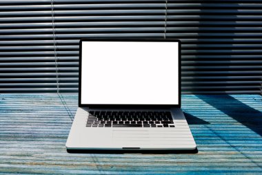 Empty home or office desktop with open laptop computer and blank copy space screen for your text message or content information