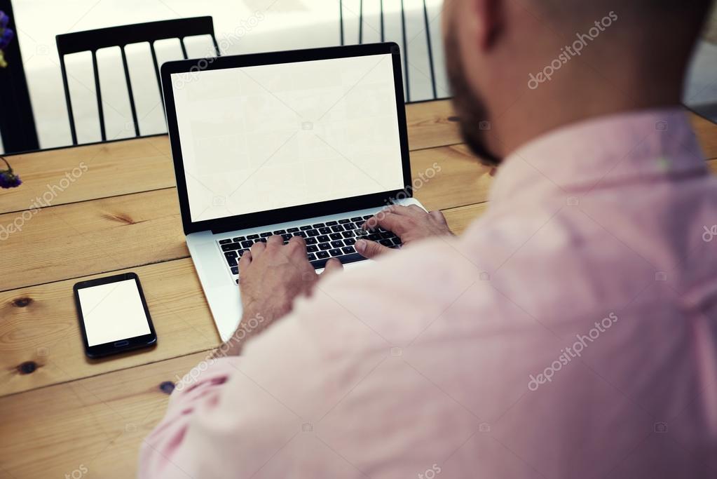 Man sitting front open laptop computer