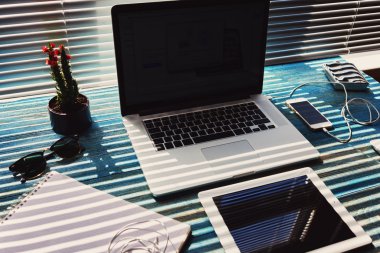 Blank screen laptop computer and digital tablet,mouse,sunglasses