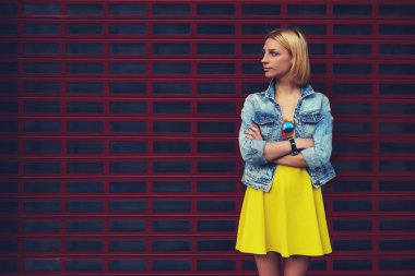 Portrait of attractive young woman standing on blank copy space background for your text message or content