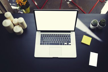 Top view of workplace with open laptop