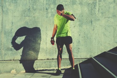tired athlete rubbing his forehead