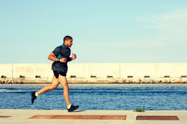 runner man working out near sea