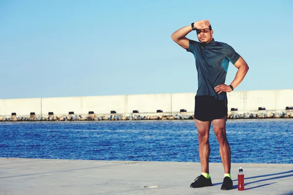 Weary sportsman rubbing his forehead — Stock Photo, Image