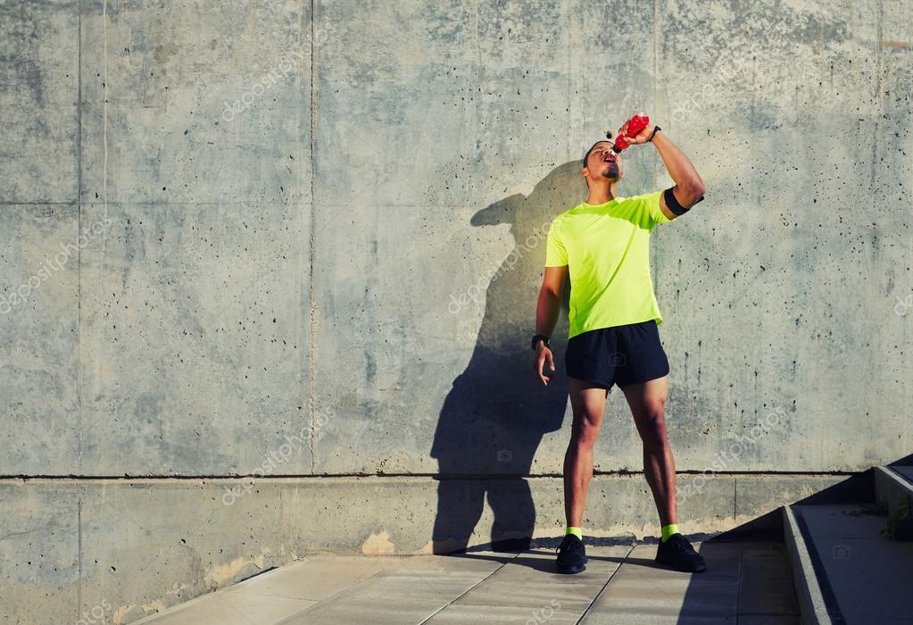 Man runner refreshing with energy drink — Stock Photo © GaudiLab 79862386