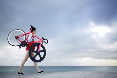woman holding her light weight bike