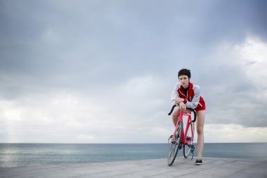 female cyclist leaning on her bicycle