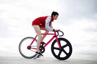 attractive hipster girl riding on bicycle