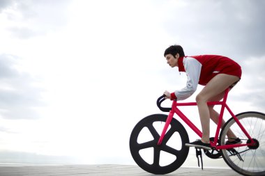 stylish female cyclist riding on bike