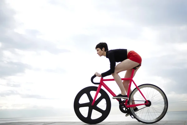 Woman cyclist riding bicycle outdoors — 스톡 사진
