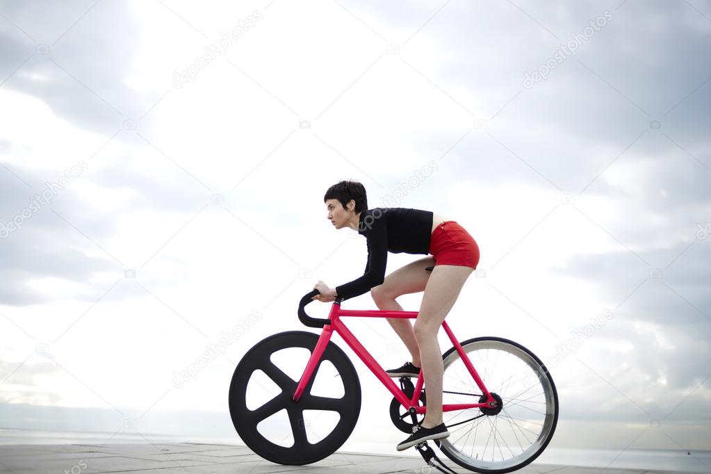 young woman ride on modern bike